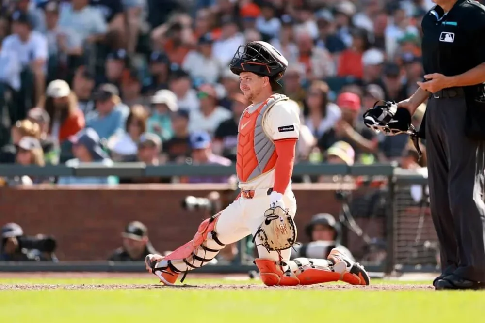 Patrick Bailey sits on his left knee behind the plate at Oracle Park.